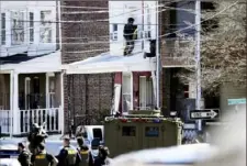  ?? Matt Rourke/Associated Press ?? Police surround a home in Trenton, N.J., on March 16, where a suspect was holding hostages after shooting three people to death in suburban Philadelph­ia. Pennsylvan­ia authoritie­s said Wednesday they plan to pursue the death penalty against Andre Gordon Jr., who is charged with the crime.