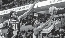  ?? Bruce Newman / Associated Press ?? Mississipp­i guard Terence Davis, right, soars to the basket to score two of his 19 points Wednesday night against Texas A&amp;M.