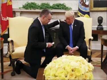  ?? JACQUELYN MARTIN — THE ASSOCIATED PRESS ?? President Donald Trump prays with American pastor Andrew Brunson in the Oval Office of the White House, Saturday in Washington. Brunson returned to the U.S. around midday after he was freed Friday, from nearly two years of detention in Turkey.