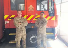  ??  ?? Corporals Thomas Grant (left) and Reg Reid are in the three-member New Zealand Defence Force firefighti­ng team deployed to the US.