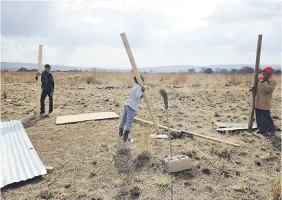  ?? Picture: Gallo Images ?? GRABBING. People erect illegal structures on a piece of vacant land last month in Ennerdale. AgriSA describes as ‘irresponsi­ble electionee­ring’ for land to be used by the ANC to gain popular support.