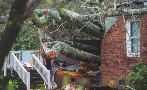  ?? AFP ?? A tree that fell on a house, killing a mother and her baby, is seen during Hurricane Florence in Wilmington, North Carolina on Friday. The hurricane battered the coastal city with strong winds and torrential rain.