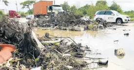  ?? SHANEL LEMMIE ?? Chesterfie­ld Drive in St Andrew is often flooded whenever it rains due to drains being blocked with garbage and other debris.