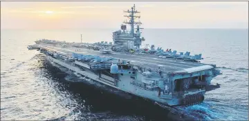  ??  ?? Picture shows the USS Ronald Reagan (CVN 76), as it patrols waters south of Japan. Ronald Reagan, the flagship of Carrier Strike Group 5, provides a combat-ready force that protects and defends the collective maritime interests of its allies and...