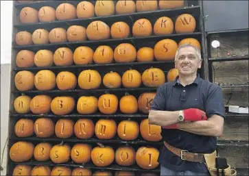  ?? PHARMACIST John Raby Associated Press ?? Ric Griffith prepares for a Halloween event in Kenova, W. Va. Griffith’s family-owned drugstore was among 250 mom-and-pop pharmacies that helped the state get off to a fast start on vaccinatio­ns.