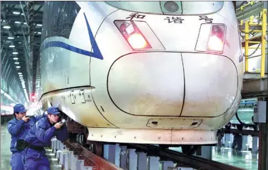  ?? XINHUA ?? Technician­s inspect bullet trains in Shanghai. China’s new-generation bullet train, the Fuxing, will make seven round trips each day between Beijing and Shanghai from Sept 21 at 350 kph.