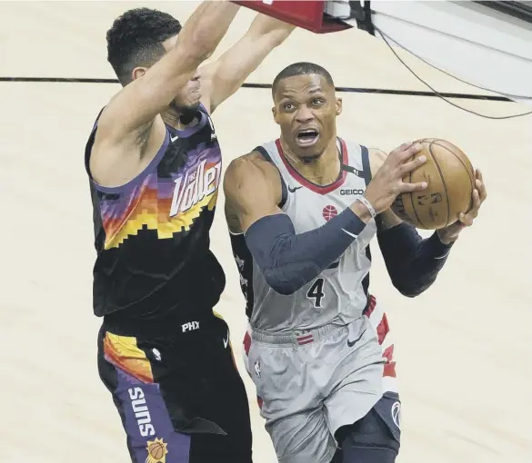  ??  ?? 0 Washington Wizards star Russell Westbrook drives to the basket past Phoenix Suns guard Devin Booker.