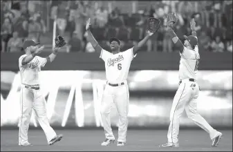  ?? AP/CHARLIE RIEDEL ?? Royals outfielder­s Alex Gordon (left), Lorenzo Cain (6) and Paulo Orlando celebrate Wednesday after their team's win against the Giants in Kansas City, Mo.