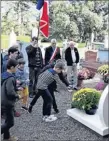  ??  ?? Les enfants déposent des fleurs au poilu du village mort pour la France.