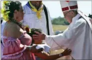  ?? ALESSANDRA TARANTINO — THE ASSOCIATED PRESS ?? A child reaches out to embrace Pope Francis in the offertory of a Mass on Wednesday at the Maquehue Air Base in Temuco, Chile.