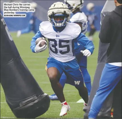  ?? KEVIN KING/WINNIPEG SUN ?? Michael Chris-ike carries the ball during Winnipeg Blue Bombers training camp yesterday.