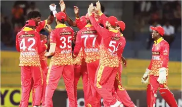  ?? ?? Chevrons teammates mob bowler Richard Ngarava after the fall of one of his five wickets against Sri Lanka yesterday