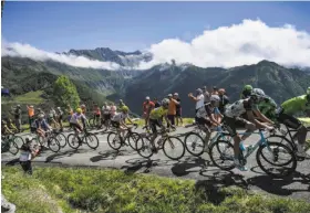  ?? Jeff Pachoud / AFP/Getty Images ?? Fabio Aru (yellow jersey, center) is in the middle of the peleton as it heads up the mountains in the Ariege region between Saint-Girons and Foix.