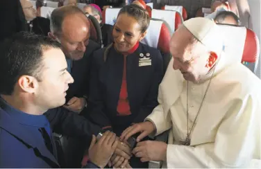  ?? Associated Press ?? In the first airborne papal wedding, Pope Francis married two Chilean flight attendants on Thursday.