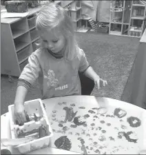  ?? Photo submitted by Lethbridge Early Years Coalition ?? Allison enjoys her creative, messy play in the Early Education Program at Immanuel Christian Elementary School.