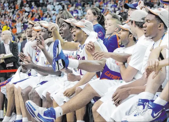  ?? Mark Humphrey The Associated Press ?? After beating Ohio State in the NCAA championsh­ip game in 2007, Florida players take the time to watch the “One Shining Moment” video.