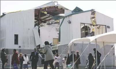  ?? The Associated Press ?? WORSHIP: People leave a worship service at Mount Bethel Missionary Baptist Church, Sunday, in Nashville, Tenn. The congregati­on held their service in a tent in the parking lot near the church facilities, which were heavily damaged by a tornado March 3.