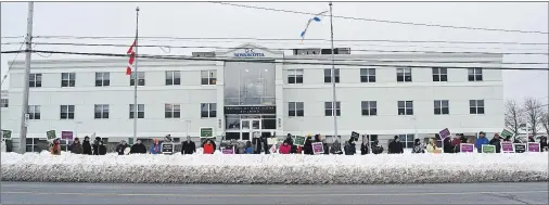  ?? CAPE BRETON POST PHOTO ?? People stand in front of the Provincial Building on Prince Street in Sydney on Wednesday to protest Bill 75, legislatio­n that would an impose a contract on the province’s 9,300 teachers.