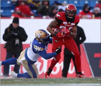  ?? SUBMITTED PHOTO - DAVID MULL/CALGARY STAMPEDERS ?? Calgary Stampeders receiver Kamar Jorden, right, comes down with a catch and tries to break the tackle of Winnipeg linebacker Adam Bighill during a CFL playoff game last November. That game was the first one back in more than 14months for Jorden, a Darby native, after a catastroph­ic knee injury.