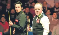  ??  ?? Ronnie O’Sullivan, left, and John Higgins are both through to the quarter-finals of the Welsh Open.