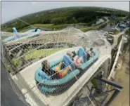  ?? AP PHOTO/CHARLIE RIEDEL, FILE ?? In this July 9, 2014, file photo, riders go down the water slide called “Verruckt” at Schlitterb­ahn Waterpark in Kansas City, Kan.