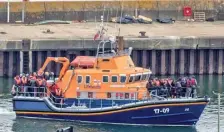  ?? ?? Risky voyage: Migrants brought into Dover Port by a lifeboat after being picked up in the English Channel on Tuesday.