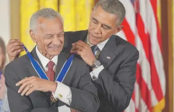  ?? MANDEL NGAN/AFP VIA GETTY IMAGES ?? The Rev. C.T. Vivian, who spent much of his childhood in western Illinois, receives the Presidenti­al Medal of Freedom from President Barack Obama in 2013.