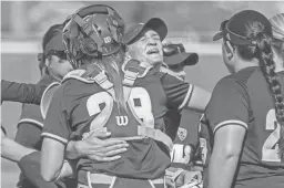  ?? JOHANNA HUCKEBA/THE REPUBLIC ?? Arizona State pitcher Breanna Macha is hugged by her teammates after striking out the final batter against Ole Miss on Saturday.