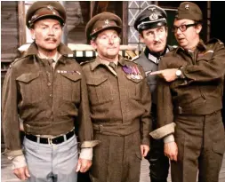  ??  ?? The army game: Ernie, Eric and Sir John Mills attempt to escape the clutches of POW camp Stalag 54 and German commandant Arnold Diamond in a 1971 sketch