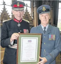  ??  ?? Flight Lieutenant Alan Bethell (right) being presented with his award