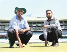  ??  ?? STADIUM manager Asif Khan, right, and groundsman Wilson Ngobese get a feel for Kingsmead’s wicket ahead of the Mzansi Super League tournament which begins this week. PICTURE: Bongani Mbatha