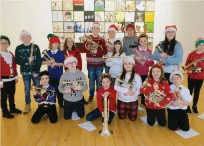  ??  ?? Young members of the Lourdes band and right, at the concert with members of the Mell school choir.