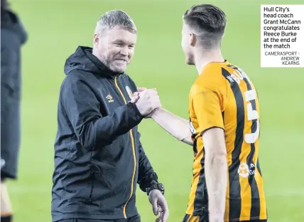 ?? CAMERASPOR­T - ANDREW KEARNS ?? Hull City’s head coach Grant Mccann congratula­tes Reece Burke at the end of the match