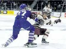 ?? CLIFFORD SKARSTEDT/EXAMINER ?? Peterborou­gh Petes' centre Jonathan Ang is checked by Mississaug­a Steelheads' defenceman Jacob Moverare during the first period of Game 4 of the OHL Eastern Conference final April 26 at the Hershey Centre in Mississaug­a. First practice will be held...