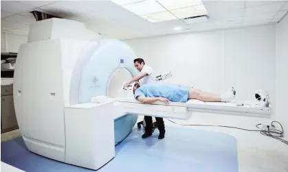  ?? ?? ‘Breath in, breathe out!’ A patient being prepared for a scan. Photograph: Thomas Barwick/Getty Images