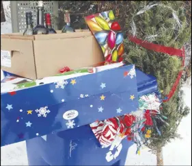  ?? CP photo ?? A blue recycling bin is shown with Christmas wrapping paper, bottles, along with other items that get thrown out after Christmas in Gatineau, Que. Canadians will send more than 540,000 tonnes of wrapping paper and gift bags to the garbage dump this year, and Christmas presents are the biggest culprit.