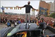  ?? GENE J. PUSKAR — THE ASSOCIATED PRESS FILE ?? In this file photo, Cleveland Cavaliers’ Kyrie Irving stands on the roof of a pickup truck before a parade celebratin­g the NBA basketball team’s championsh­ip, in downtown Cleveland. Four months after LeBron James and the Cavaliers ended the city’s...