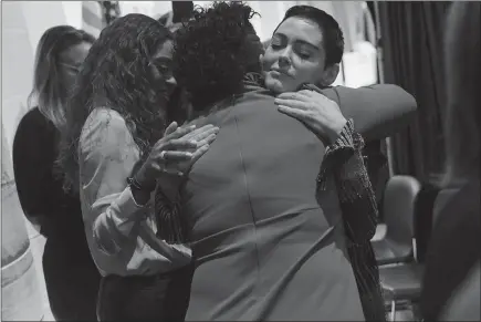  ?? PHOTOS BY ERIN KIRKLAND / THE NEW YORK TIMES ?? Rose Mcgowan embraces a supporter before taking the stage to speak Friday at the opening session of the Women’s Convention at the Cobo Center in Detroit. Mcgowan, who has accused Hollywood producer Harvey Weinstein of raping her, told the crowd, “I have been silenced for 20 years. I have been slut-shamed. I have been harassed. I have been maligned. And you know what? I’m just like you.”