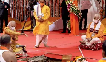  ?? PTI ?? HISTORIC DAY: Narendra Modi performs the groundbrea­king ceremony of the Ram temple as RSS chief Mohan Bhagwat (right) looks on in Ayodhya, Uttar Pradesh, on Wednesday. —