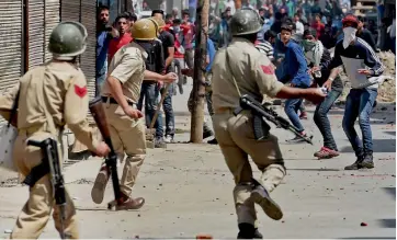  ??  ?? Policemen fire teargas shells towards stone pelters during a clash in Srinagar on Tuesday after a protest by Congress workers against the BJP- PDP government’s alleged anti- people policies. ■ More on Page 2