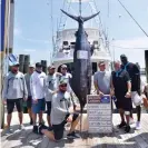  ?? Photograph: Grace Bell/AP ?? Michael Jordan, right, and the crew of his 80ft fishing boat named Catch 23 in June.