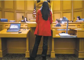  ?? Photos by Jessica Christian / The Chronicle ?? Rachel Sutton speaks about her experience reporting a sexual assault, describing what she called “negligence and incompeten­ce,” during a Board of Supervisor­s committee hearing.