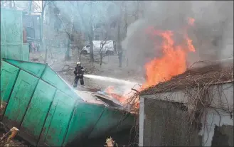  ?? SERGEY BOBOK / AGENCE FRANCE-PRESSE ?? Firefighte­rs extinguish a fire at the site of a missile strike in the center of Kharkiv on Sunday. The city has seen increased deadly attacks in recent months.