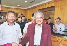  ??  ?? Dr Mahathir (right) arrives at the VVIP lounge of the KIA.