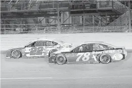  ?? LYNNE SLADKY/AP ?? Joey Logano (22) and Martin Truex Jr. (78) race during the NASCAR Cup Series Championsh­ip race at the Homestead-Miami Speedway on Sunday.