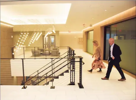  ?? Tyler Sizemore / Hearst Connecticu­t Media ?? Charter Senior Vice President of Communicat­ions Cameron Blanchard and Senior Vice President of Corporate Services Mike Reid walk through the top floor lobby at the new Charter Communicat­ions headquarte­rs at 406 Washington Blvd. in Stamford on Nov. 17.