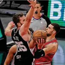  ?? Jonathan Daniel / Getty Images ?? Even when the Spurs’ offense was struggling against the Bulls, Jakob Poeltl, left, was a bright spot on both ends of the floor.