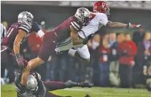  ?? KENT GIDLEY/ALABAMA PHOTO ?? Alabama receiver Cam Sims lunges for more yardage during an 18-yard catch Saturday night at Mississipp­i State. Alabama won 31-24.