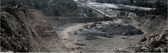  ?? Dmitry Lovetsky/the Associated Press ?? Excavators move earth at a quarry near Akhshtyr Village in Sochi. Opponents of the Games have expressed concern about water supply being contaminat­ed by constructi­on.