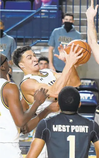  ?? PAUL W GILLESPIE | CAPITAL GAZETTE ?? Navy’s Greg Summers pulls in an offensive rebound in the first half against Army on Saturday at Alumni Hall in Annapolis.